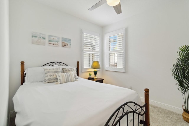 carpeted bedroom with baseboards and a ceiling fan