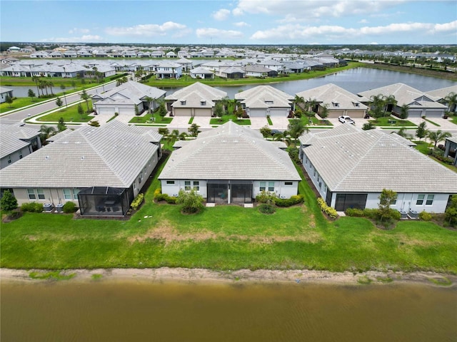 aerial view of residential area featuring a large body of water
