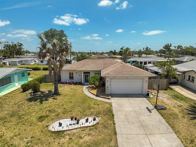 1789 Elm Dr, Venice, FL 34293 - ranch-style house with a front yard, a shingled roof, driveway, an attached garage, and fence