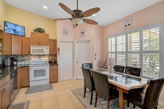 1789 Elm Dr, Venice, FL 34293 - kitchen with tasteful backsplash, white appliances, a wealth of natural light, ceiling fan, and light tile patterned flooring