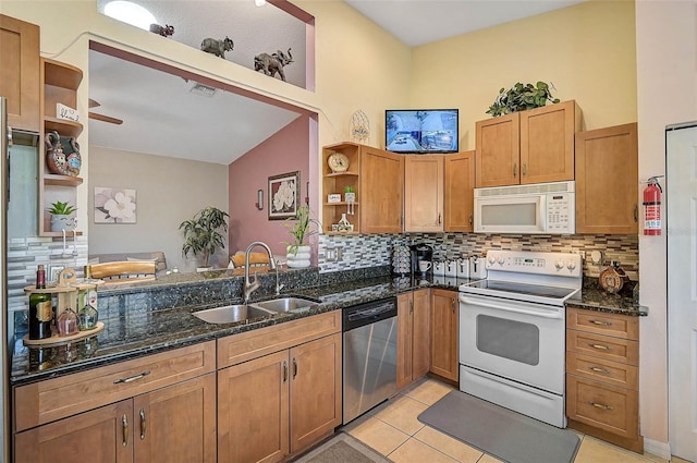 1789 Elm Dr, Venice, FL 34293 - kitchen featuring dark stone counters, a sink, open shelves, backsplash, and white appliances