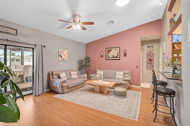 1789 Elm Dr, Venice, FL 34293 - living area with light wood-style flooring, vaulted ceiling, baseboards, visible vents, and a ceiling fan