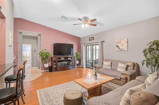 1789 Elm Dr, Venice, FL 34293 - living room with lofted ceiling, visible vents, ceiling fan, and plenty of natural light