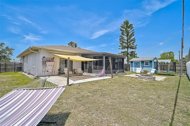 1789 Elm Dr, Venice, FL 34293 - rear view of property with a patio, an outdoor fire pit, a sunroom, a yard, and a fenced backyard