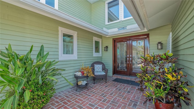 property entrance with a patio area and french doors
