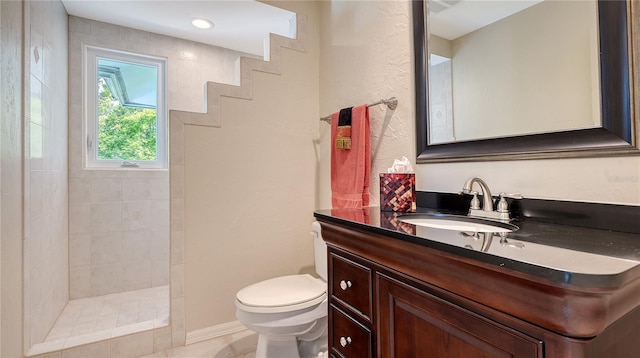 full bathroom featuring walk in shower, toilet, vanity, tile patterned flooring, and a textured wall