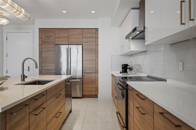 111 S Pineapple Ave Unit 716, Sarasota, FL 34236 - kitchen with a sink, appliances with stainless steel finishes, brown cabinets, and marble finish floor