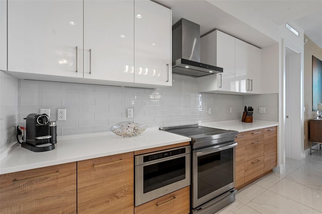 111 S Pineapple Ave Unit 716, Sarasota, FL 34236 - kitchen with white cabinetry, modern cabinets, stainless steel electric stove, and wall chimney range hood