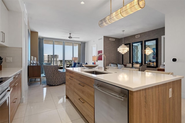 111 S Pineapple Ave Unit 716, Sarasota, FL 34236 - kitchen featuring ceiling fan, appliances with stainless steel finishes, a sink, light countertops, and modern cabinets