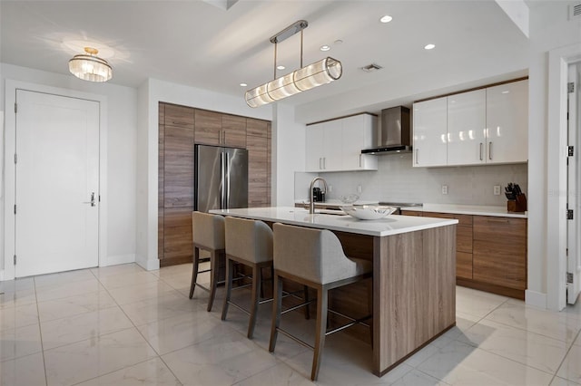111 S Pineapple Ave Unit 716, Sarasota, FL 34236 - kitchen featuring a kitchen breakfast bar, a sink, modern cabinets, and wall chimney exhaust hood