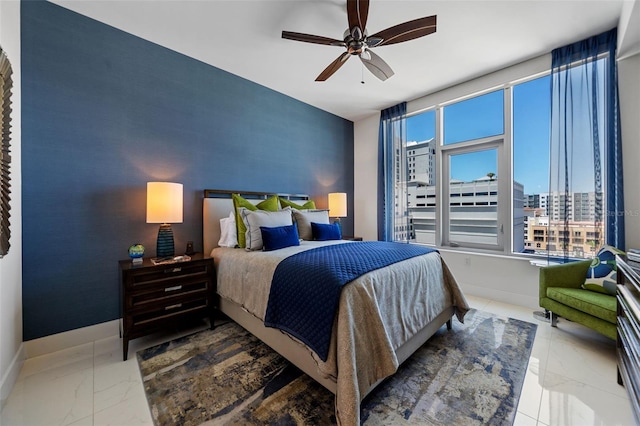 111 S Pineapple Ave Unit 716, Sarasota, FL 34236 - bedroom featuring baseboards, a ceiling fan, marble finish floor, and an accent wall