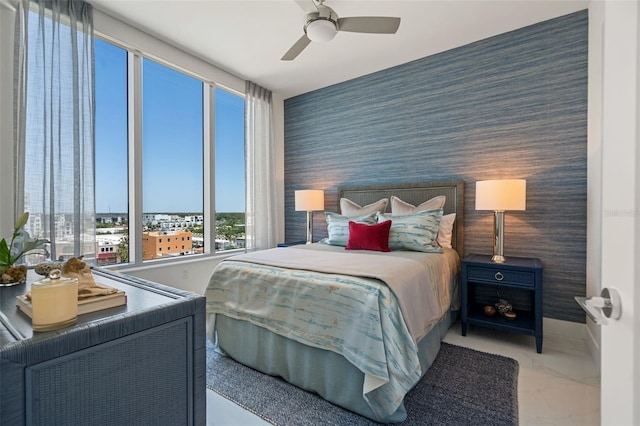 111 S Pineapple Ave Unit 716, Sarasota, FL 34236 - bedroom with marble finish floor, wallpapered walls, a ceiling fan, and an accent wall