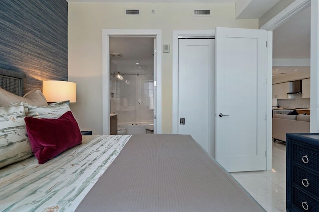 111 S Pineapple Ave Unit 716, Sarasota, FL 34236 - bedroom featuring connected bathroom, visible vents, and a closet