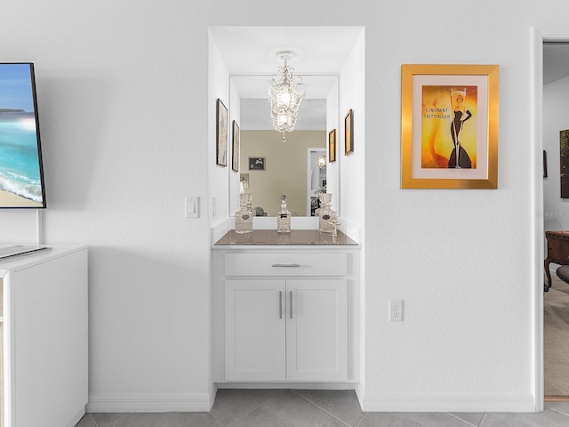 14214 Heritage Landing Blvd Unit 817, Punta Gorda, FL 33955 - bathroom with tile patterned flooring, baseboards, vanity, and a chandelier