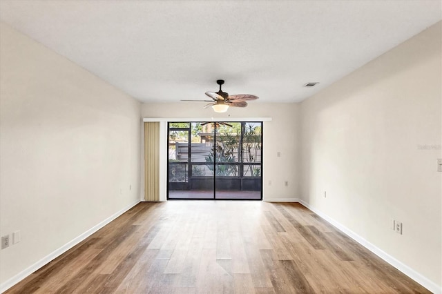 752 White Pine Tree Rd Unit 101, Venice, FL 34285 - empty room featuring visible vents, ceiling fan, wood finished floors, and baseboards