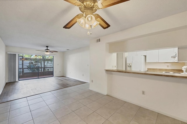 752 White Pine Tree Rd Unit 101, Venice, FL 34285 - unfurnished living room with light tile patterned floors, a sink, baseboards, visible vents, and a ceiling fan