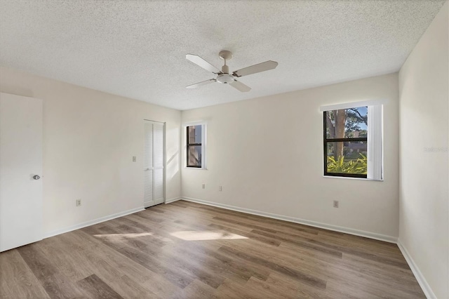 752 White Pine Tree Rd Unit 101, Venice, FL 34285 - empty room featuring a textured ceiling, wood finished floors, and ceiling fan