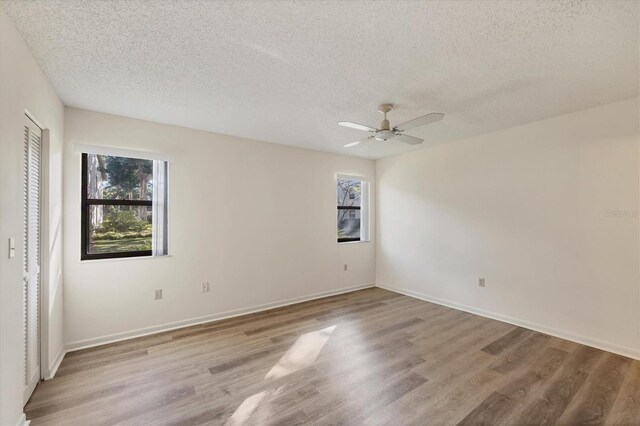 752 White Pine Tree Rd Unit 101, Venice, FL 34285 - spare room featuring a textured ceiling and a healthy amount of sunlight