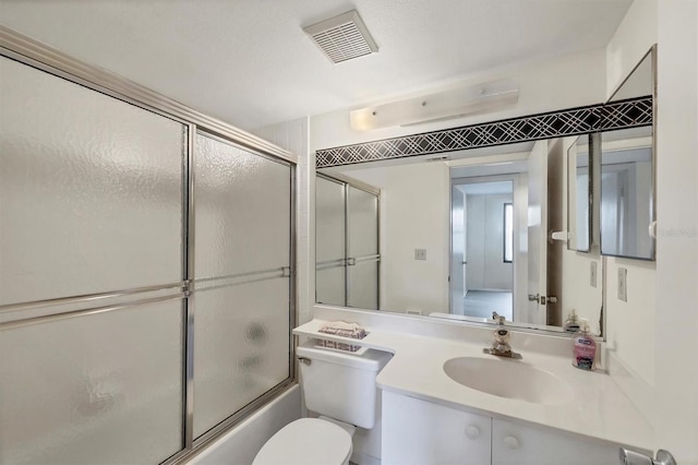 752 White Pine Tree Rd Unit 101, Venice, FL 34285 - full bathroom with visible vents, toilet, shower / bath combination with glass door, and vanity