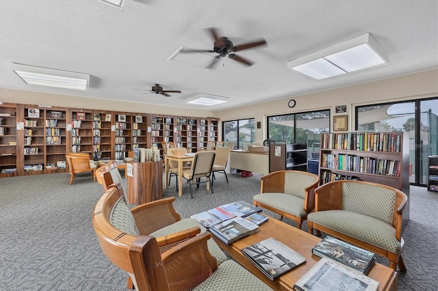 752 White Pine Tree Rd Unit 101, Venice, FL 34285 - sitting room with a textured ceiling, a ceiling fan, and carpet flooring