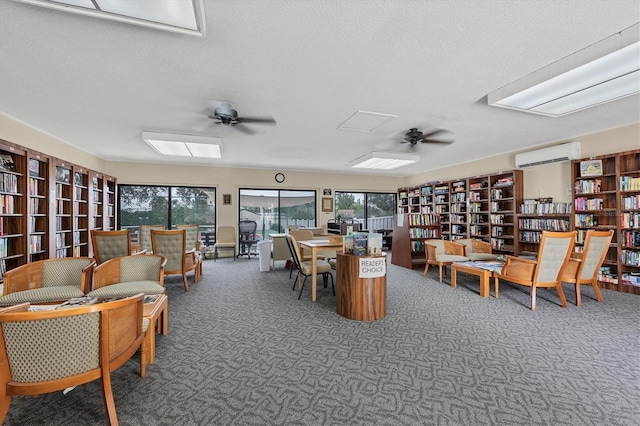 752 White Pine Tree Rd Unit 101, Venice, FL 34285 - interior space featuring a textured ceiling, ceiling fan, and a wall mounted air conditioner