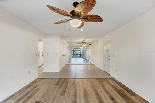 752 White Pine Tree Rd Unit 101, Venice, FL 34285 - unfurnished room with baseboards, wood finished floors, and a ceiling fan