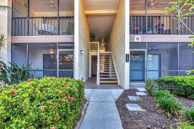 752 White Pine Tree Rd Unit 101, Venice, FL 34285 - doorway to property featuring stucco siding and a ceiling fan