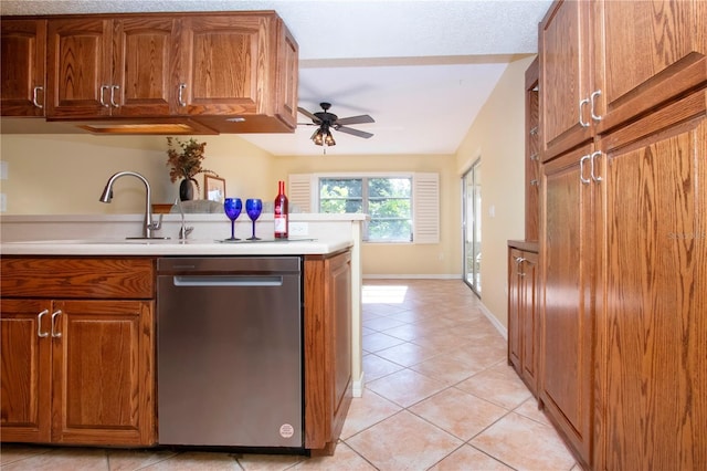 3843 El Poinier Ct W Unit 8720, Sarasota, FL 34232 - kitchen with stainless steel dishwasher, a ceiling fan, light tile patterned floors, and brown cabinets