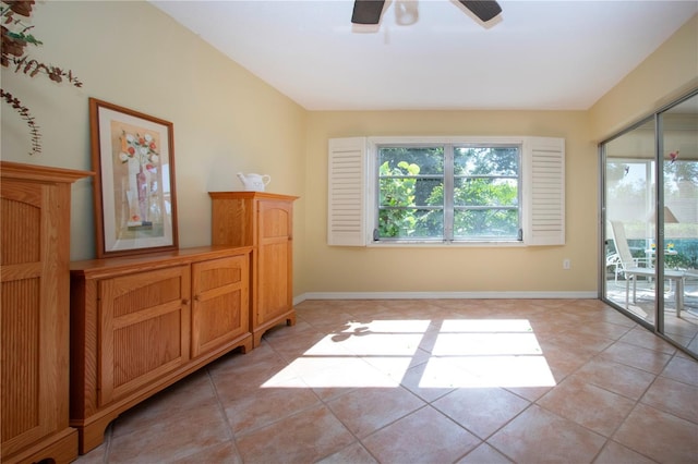 3843 El Poinier Ct W Unit 8720, Sarasota, FL 34232 - unfurnished room featuring plenty of natural light, a ceiling fan, light tile patterned flooring, and baseboards