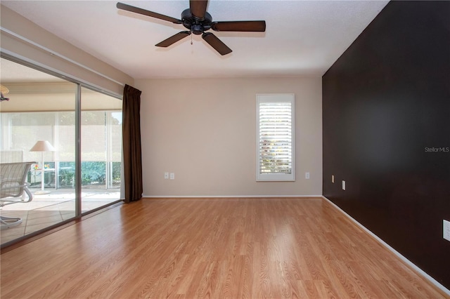3843 El Poinier Ct W Unit 8720, Sarasota, FL 34232 - unfurnished room featuring wood finished floors, plenty of natural light, a ceiling fan, and baseboards