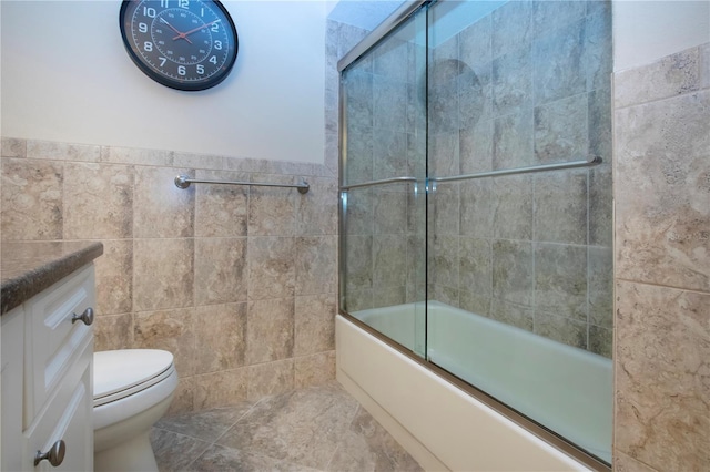 3843 El Poinier Ct W Unit 8720, Sarasota, FL 34232 - full bathroom featuring tile walls, vanity, combined bath / shower with glass door, and toilet
