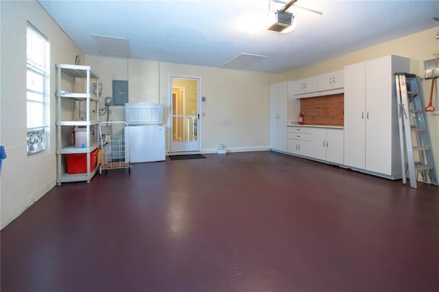 3843 El Poinier Ct W Unit 8720, Sarasota, FL 34232 - garage with a garage door opener, electric panel, and baseboards