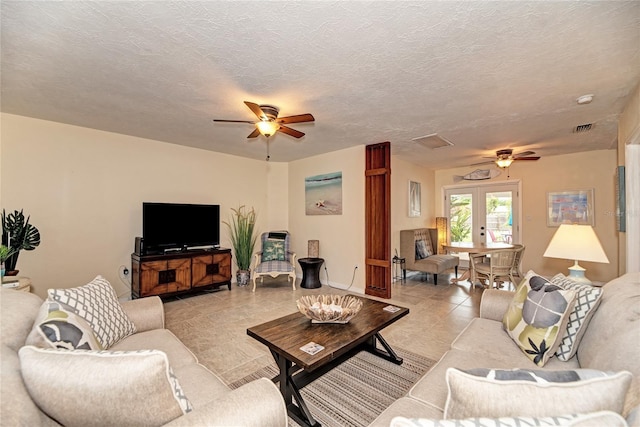 living area with light tile patterned floors, ceiling fan, and visible vents