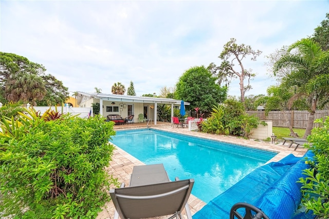 view of swimming pool featuring a patio, a fenced in pool, and a fenced backyard