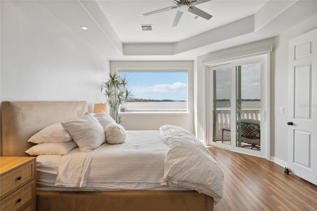bedroom with ceiling fan, visible vents, access to exterior, baseboards, and wood finished floors