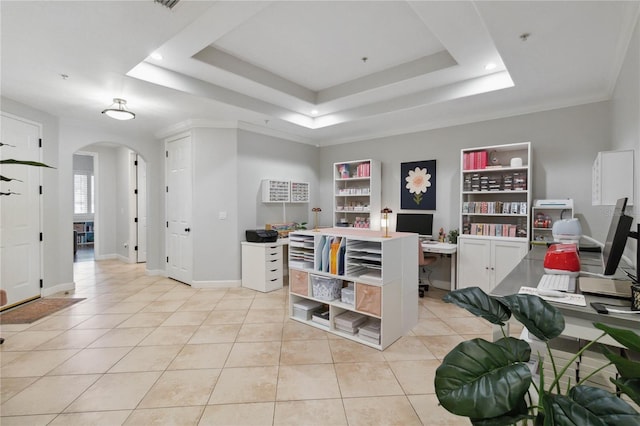 interior space with light tile patterned floors, a raised ceiling, baseboards, and arched walkways