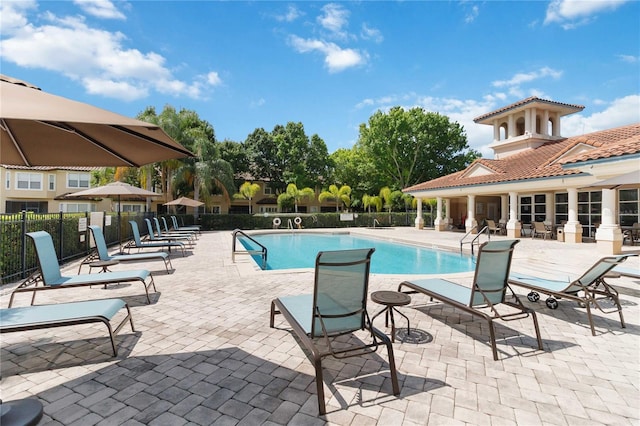 pool featuring fence and a patio area
