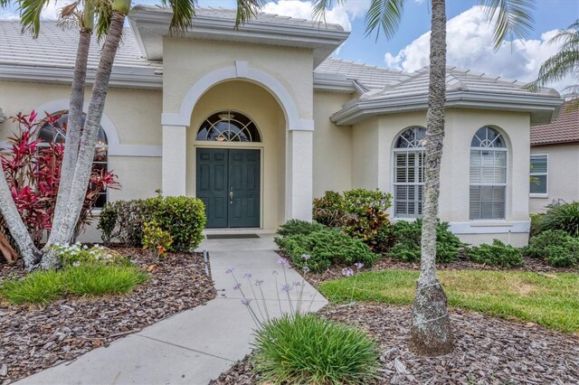 5106 Far Oak Cir, Sarasota, FL 34238 - entrance to property featuring stucco siding and a tiled roof
