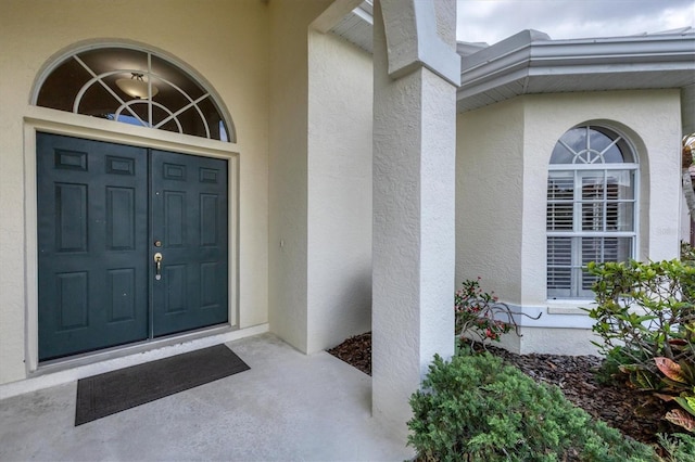 5106 Far Oak Cir, Sarasota, FL 34238 - doorway to property featuring covered porch and stucco siding