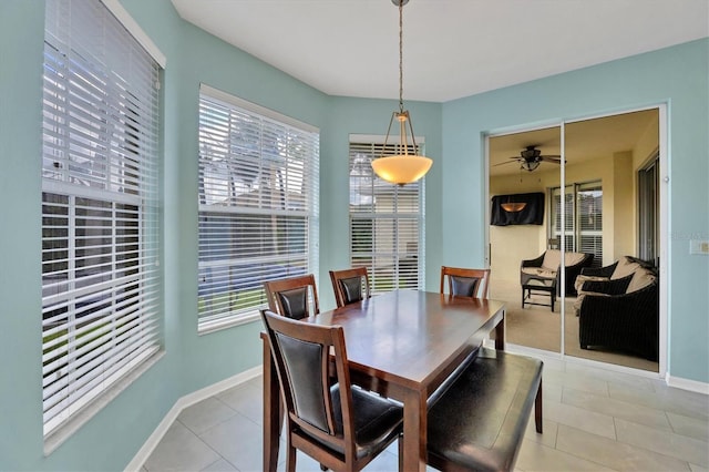 5106 Far Oak Cir, Sarasota, FL 34238 - dining space with baseboards, a ceiling fan, light tile patterned floors, and a wealth of natural light