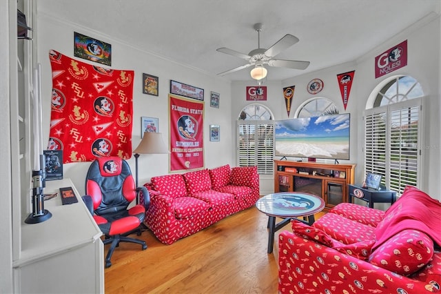5106 Far Oak Cir, Sarasota, FL 34238 - living area with crown molding, plenty of natural light, a ceiling fan, and wood finished floors