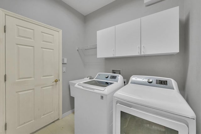 5106 Far Oak Cir, Sarasota, FL 34238 - clothes washing area with baseboards, cabinet space, and washing machine and clothes dryer