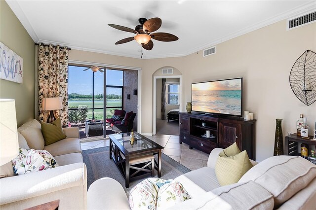 tiled living room with a ceiling fan, ornamental molding, and baseboards