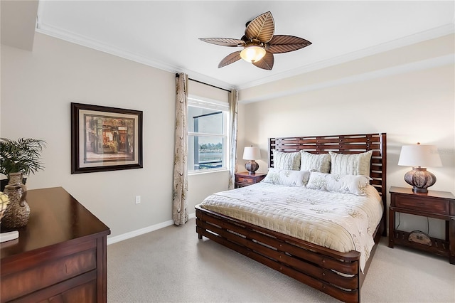 bedroom featuring crown molding, light colored carpet, baseboards, and a ceiling fan