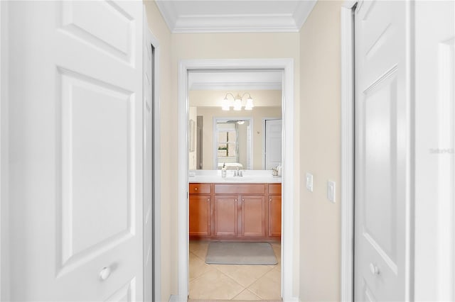 bathroom with crown molding, vanity, tile patterned floors, and a chandelier
