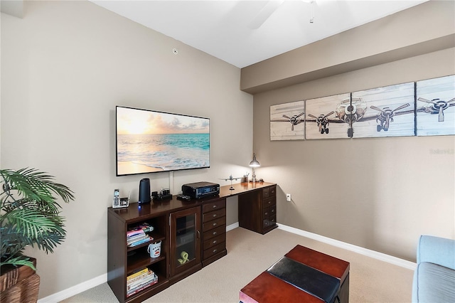 carpeted home office featuring baseboards and ceiling fan