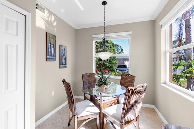 dining room featuring crown molding, plenty of natural light, light tile patterned floors, and baseboards