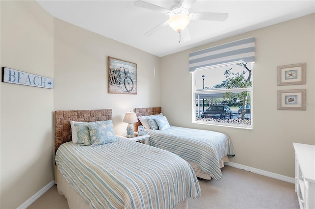 bedroom with light carpet, baseboards, and ceiling fan