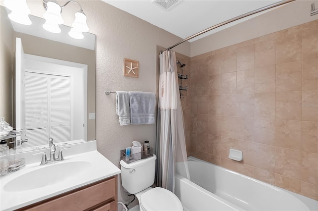 full bathroom featuring a textured wall, vanity, shower / bath combo, and toilet