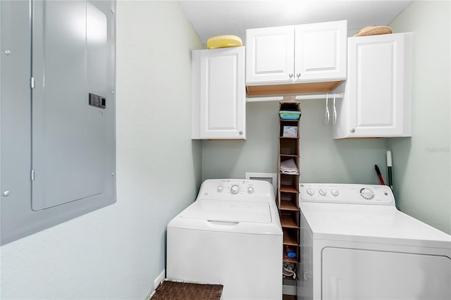 laundry area with cabinet space, washing machine and clothes dryer, and electric panel